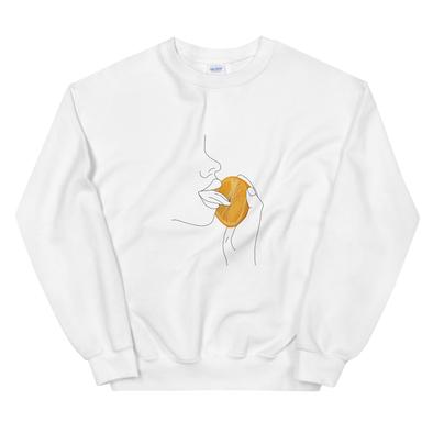 White sweatshirt with an illustration of a person sensually licking an orange